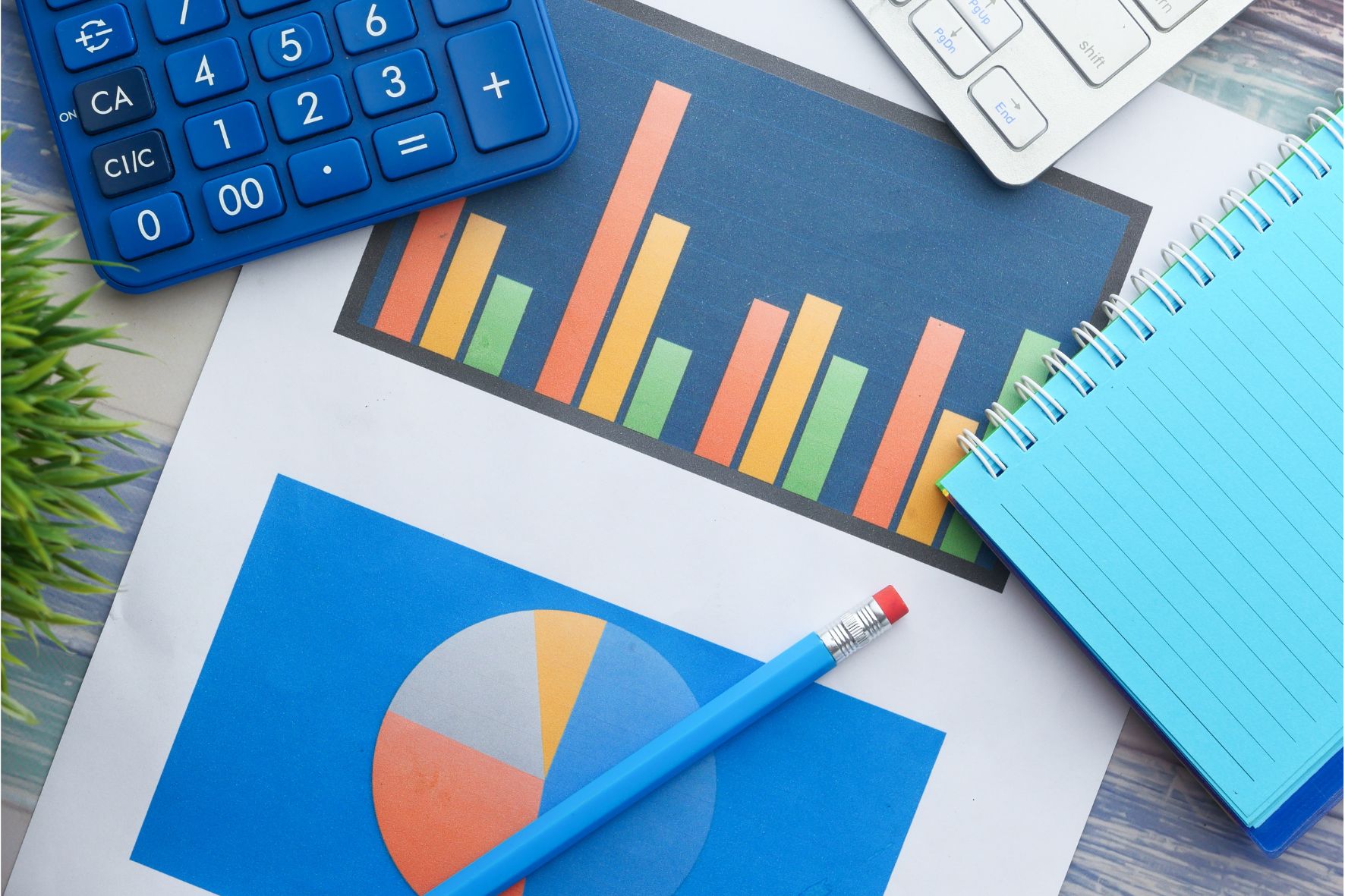 Detailed CRO analysis with bar graph and pie chart on paper, blue calculator and keyboard visible, highlighting data-driven strategies in eCommerce.