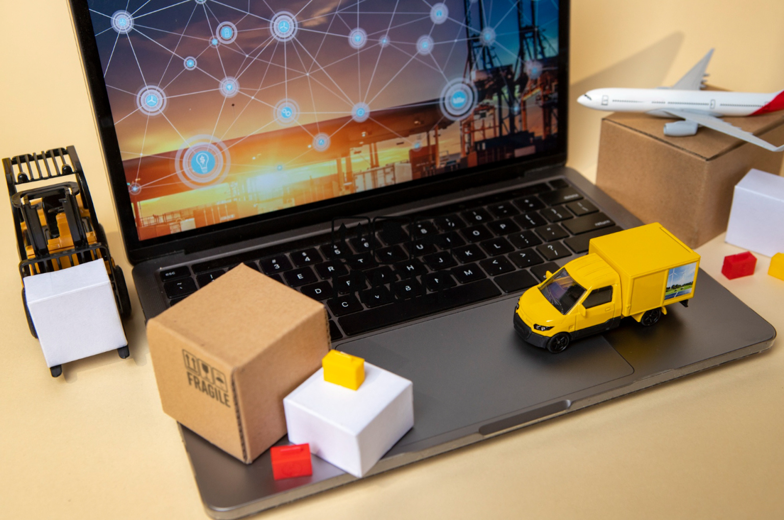 E-commerce logistics concept with miniatures of a delivery truck, airplane, and packages on a laptop, symbolizing the shipping process and its role in customer conversion.