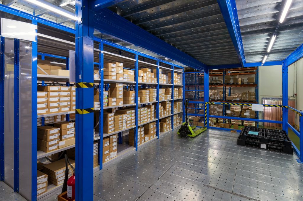 Interior of a modern warehouse showing organized shelves stocked with boxes, exemplifying efficient ecommerce inventory management.